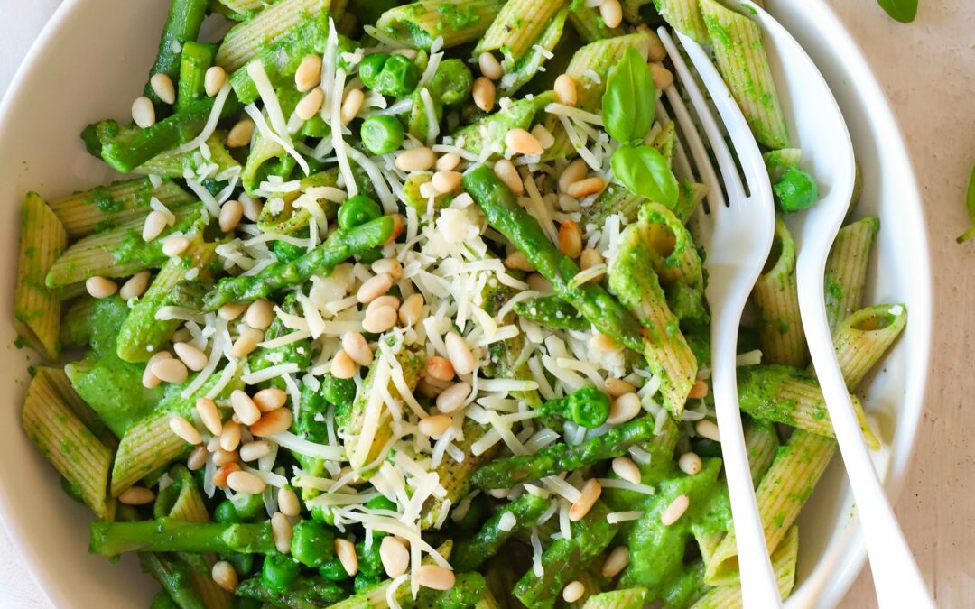 Vegetarische lentepasta met pesto, erwtjes, groene asperges en gemalen kaas